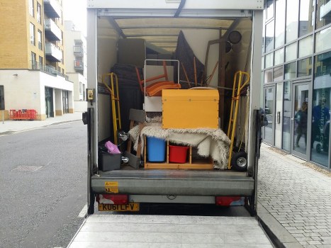 Man and van loading items from a flat